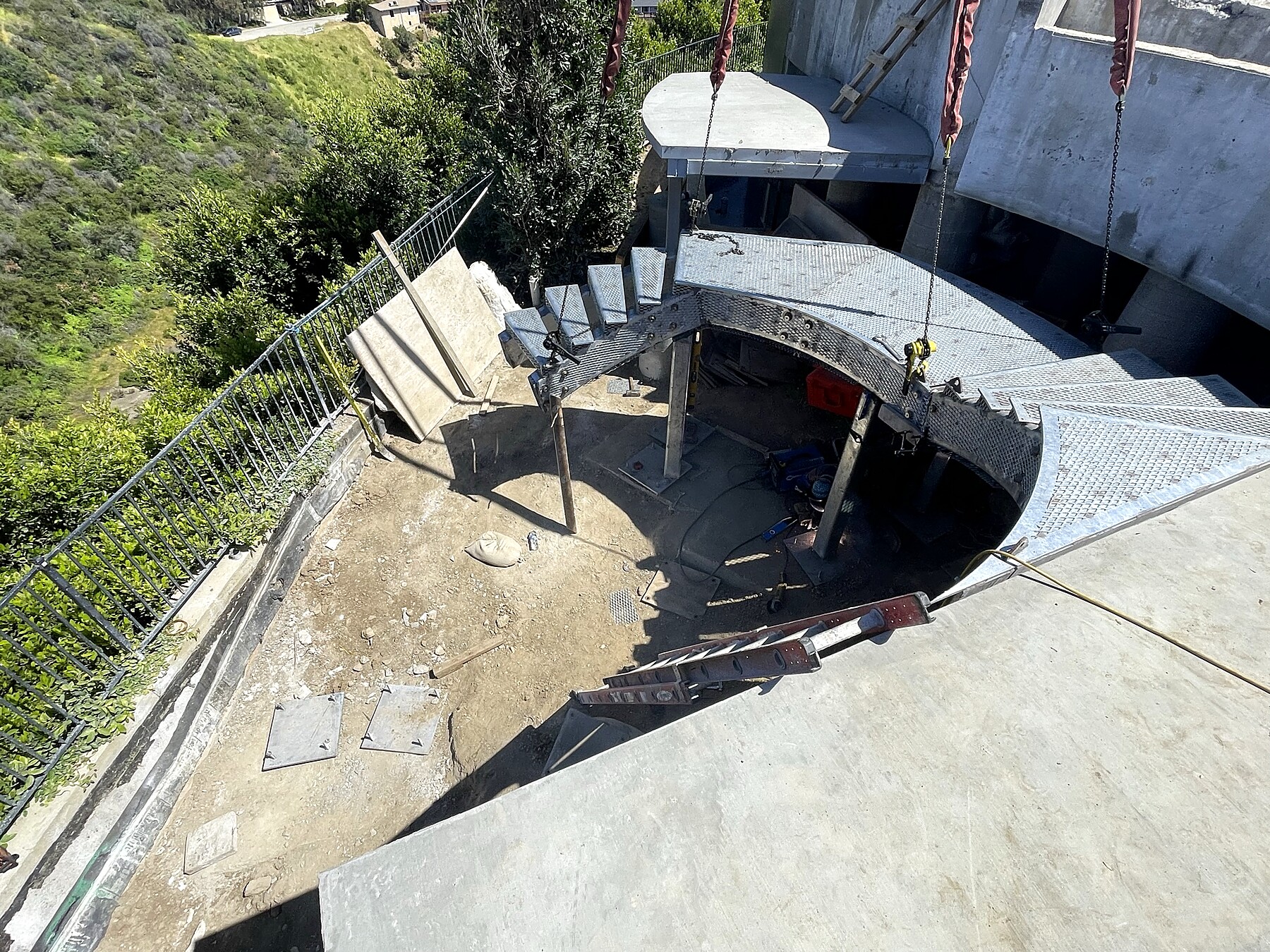 Curved steel stair structure, construction phase, coastal site
