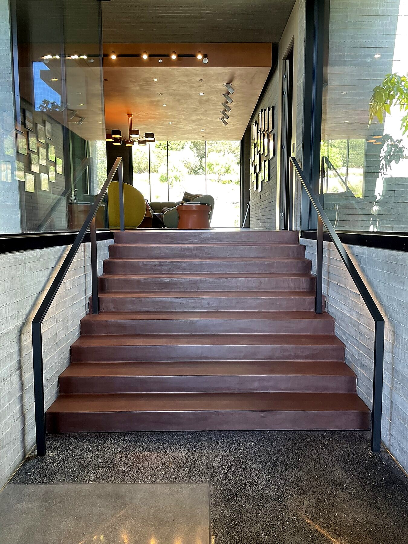 LED-lit handrail on a concrete stair, custom fabrication