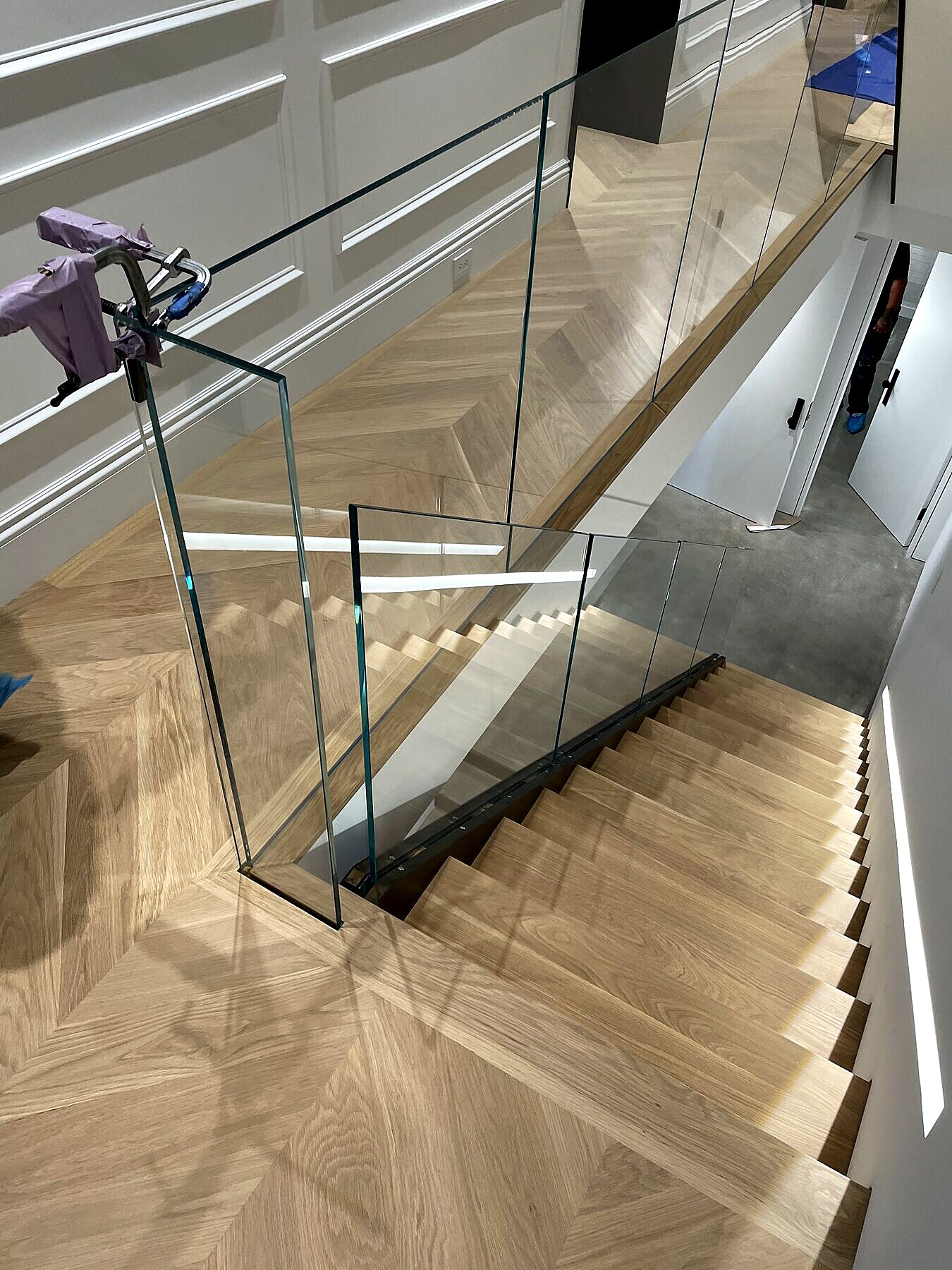 Wood tread staircase with structural glass rail package, natural light